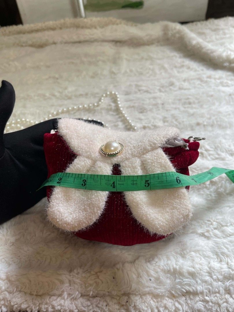 Red Sparkly Mini Purse with Pearl Strap (Category: Purses & Pouches) located in Naawan. Submitted by twilly.apparel2 (Listing ID 1462913743, Image 3). Description: - Cute sparkly red purse - Fluffy white bow with pearl accent on the front - Comes with a pearl strap - Ideal for kids or as a fun, stylish accessory - Approximately 4 inches wide.