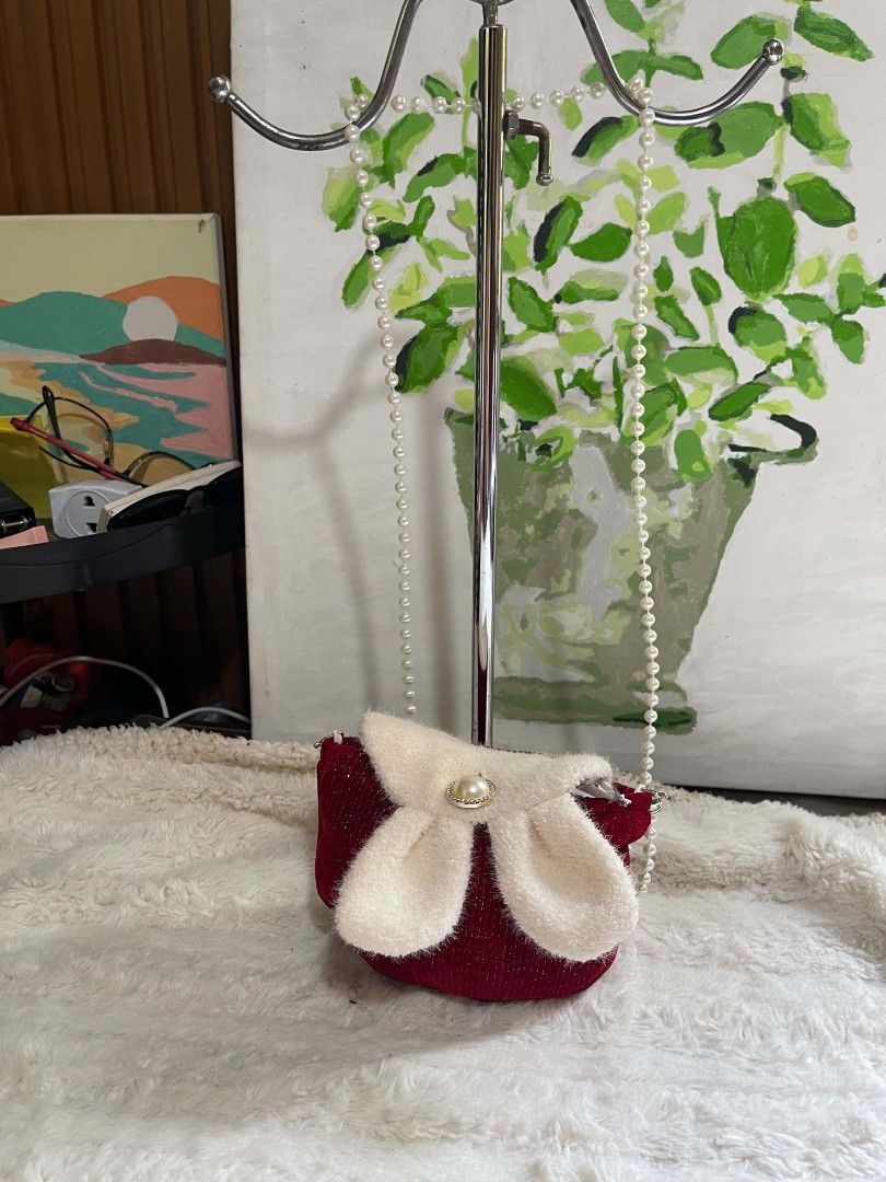 Red Sparkly Mini Purse with Pearl Strap (Category: Purses & Pouches) located in Naawan. Submitted by twilly.apparel2 (Listing ID 1462913743, Image 1). Description: - Cute sparkly red purse - Fluffy white bow with pearl accent on the front - Comes with a pearl strap - Ideal for kids or as a fun, stylish accessory - Approximately 4 inches wide.