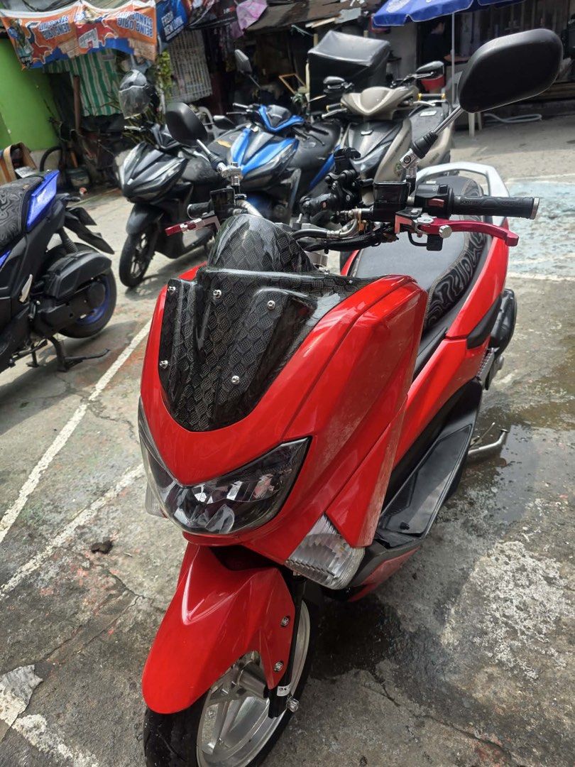 Red Yamaha NMAX (Category: Motorbikes for Sale) located in Manila. Submitted by polengg_whale (Listing ID 1462974387, Image 1). Description: Selling my red Yamaha NMAX. It has a carbon fiber windshield and a custom exhaust. The seat has a unique pattern. Great for city riding. Well maintained and runs smoothly. Ready for a new owner. Message me for more details or to arrange a viewing..