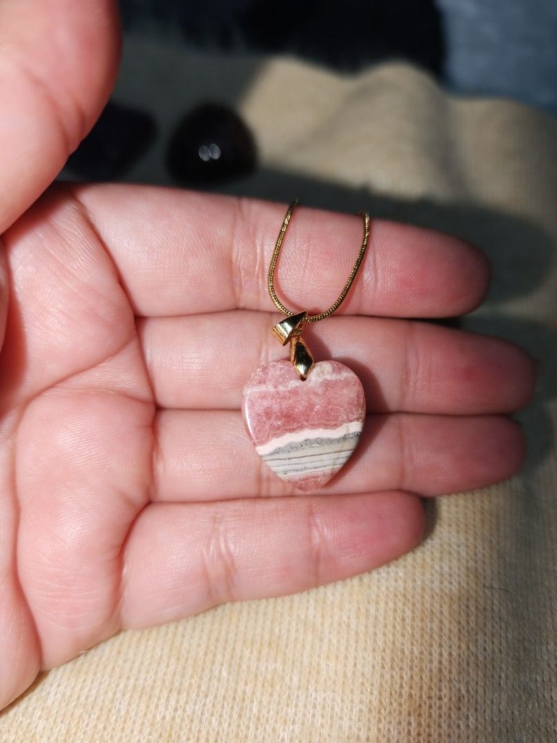 Rhodochrosite Heart Pendant (Category: Necklaces) located in Quezon City. Submitted by piaoliangcollections.ph (Listing ID 1463096878, Image 3). Description: Made From Natural Stone of Rhodochrosite. Emotional and Spiritual Benefits Self-Love: Encourages self-acceptance, personal worth, and a gentle appreciation for your own traits. Heart Healing: Known as the "Stone of the Compassionate Heart," it helps soothe past grief, childhood trauma, and l