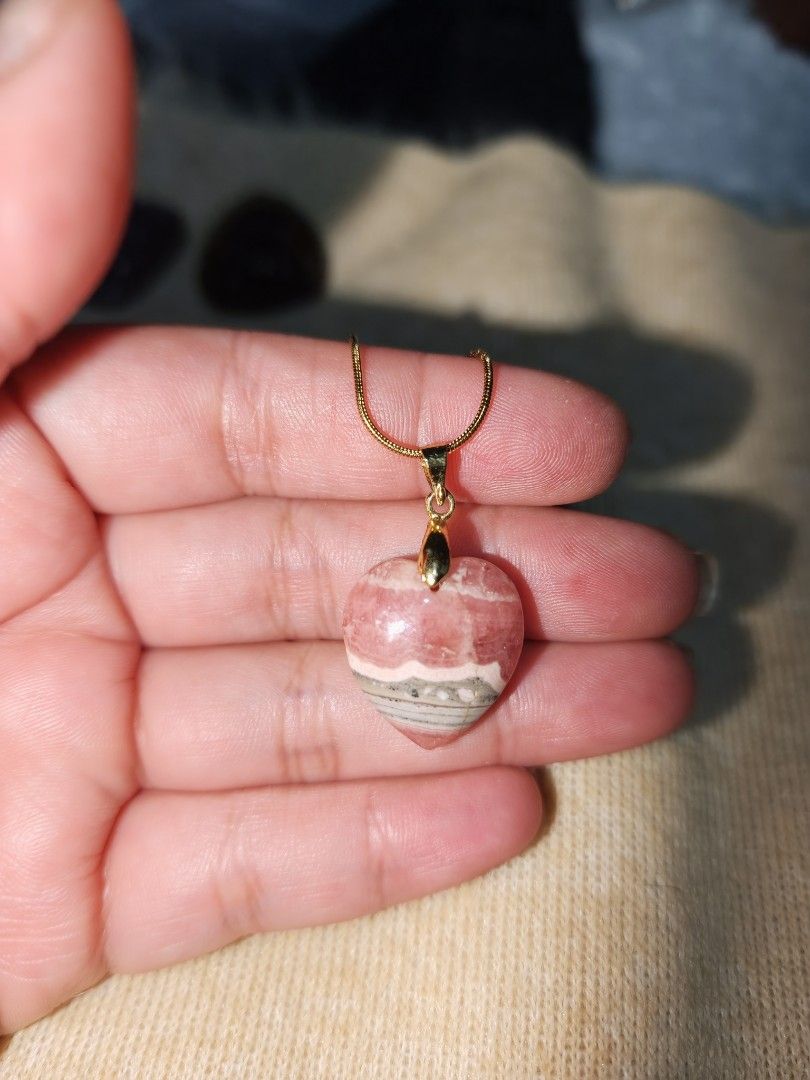 Rhodochrosite Heart Pendant (Category: Necklaces) located in Quezon City. Submitted by piaoliangcollections.ph (Listing ID 1463096878, Image 1). Description: Made From Natural Stone of Rhodochrosite. Emotional and Spiritual Benefits Self-Love: Encourages self-acceptance, personal worth, and a gentle appreciation for your own traits. Heart Healing: Known as the "Stone of the Compassionate Heart," it helps soothe past grief, childhood trauma, and l