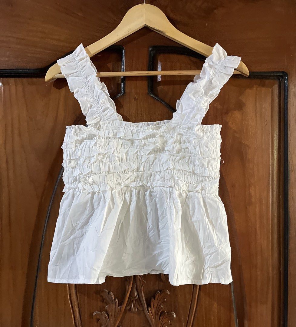 RUFFLED SHOULDER STRAP WHITE SMOCKED CROP-top (Category: Others Tops) located in Manila. Submitted by dinielajean.com (Listing ID 1463009719, Image 1). Description: ❗️RUFFLED SHOULDER STRAP WHITE SMOCKED CROP-top RANDOM S-M garterize THRIFT NOT PRELOVED😤 Color rate: 9.5/10🎉 Good as new✅ DM📥.