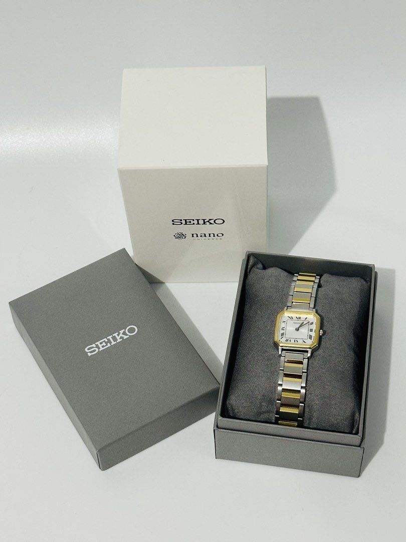 Seiko x nano universe watch (Category: Women's Watches) located in Manila. Submitted by luxe_aethel (Listing ID 1463109319, Image 1). Description: - Seiko x nano universe collaboration watch - Elegant two-tone metal strap (silver and gold) - Classic square watch face with Roman numerals - Comes with original Seiko boxes - Versatile for everyday wear and special events.