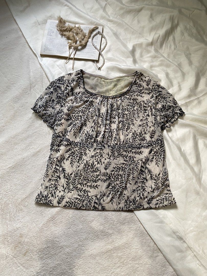 Sheer Leaf Print Puff Sleeve Top Small 34 (Category: Blouses) located in Poro. Submitted by joyceyuu (Listing ID 1462924011, Image 1). Description: - Lightweight sheer fabric - Delicate leaf print - Gathered detailing at the bust - Short puff sleeves - Subtle textured trim neckline - Versatile for layering or wearing on its own - Easy to style for casual or dressier occasions.