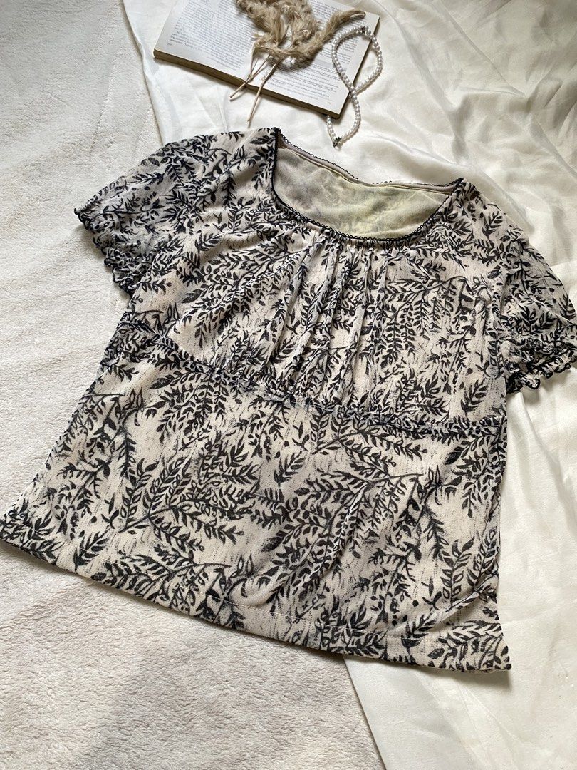 Sheer Leaf Print Puff Sleeve Top Small 34 (Category: Blouses) located in Poro. Submitted by joyceyuu (Listing ID 1462924011, Image 2). Description: - Lightweight sheer fabric - Delicate leaf print - Gathered detailing at the bust - Short puff sleeves - Subtle textured trim neckline - Versatile for layering or wearing on its own - Easy to style for casual or dressier occasions.