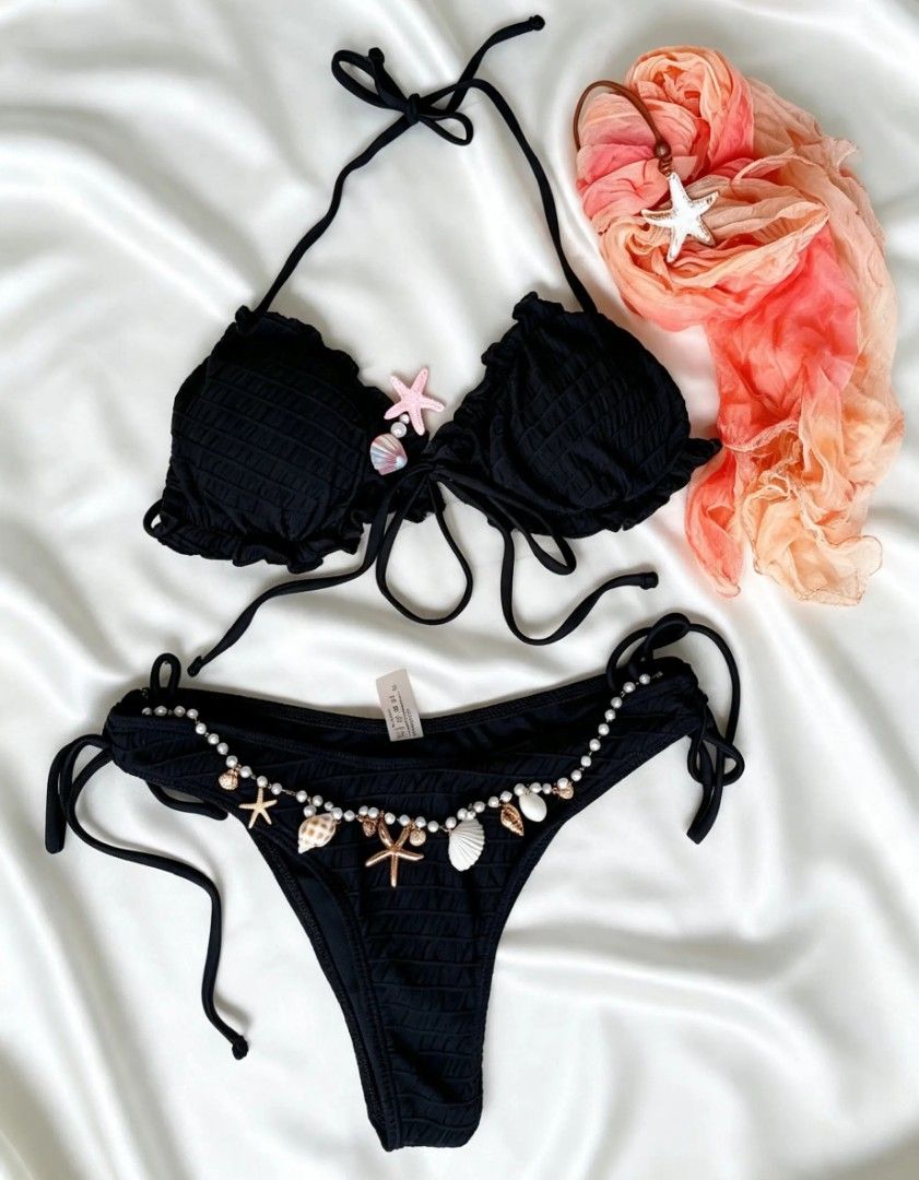SHEIN Black Bikini 3in1 (Category: Bikinis & Swimsuits) located in Compostela. Submitted by shopbybeverly (Listing ID 1463007754, Image 2). Description: - SHEIN black bikini set - Ruffled halter top - Tie-side bottoms with beaded trim - Adorable shell and starfish charms on bottoms - Includes sheer pink and orange scarf - Ideal for beach or pool days.