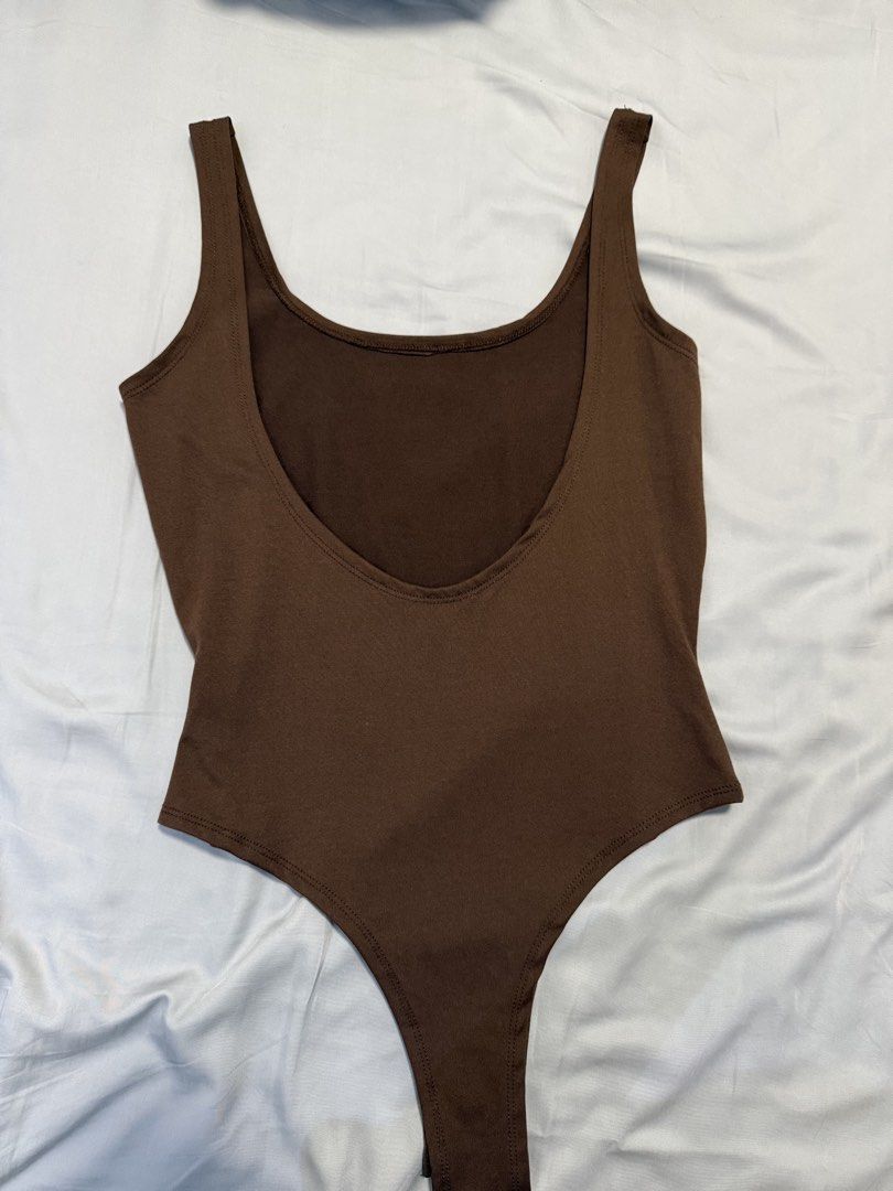 SHEIN Brown Scoop Neck Bodysuit (Category: Others Tops) located in Dasmarinas. Submitted by denmae (Listing ID 1462905677, Image 2). Description: - Brown scoop neck bodysuit from SHEIN - Made of comfortable and stretchy polyester/spandex blend - Versatile basic for layering or wearing on its own -Low back detail.
