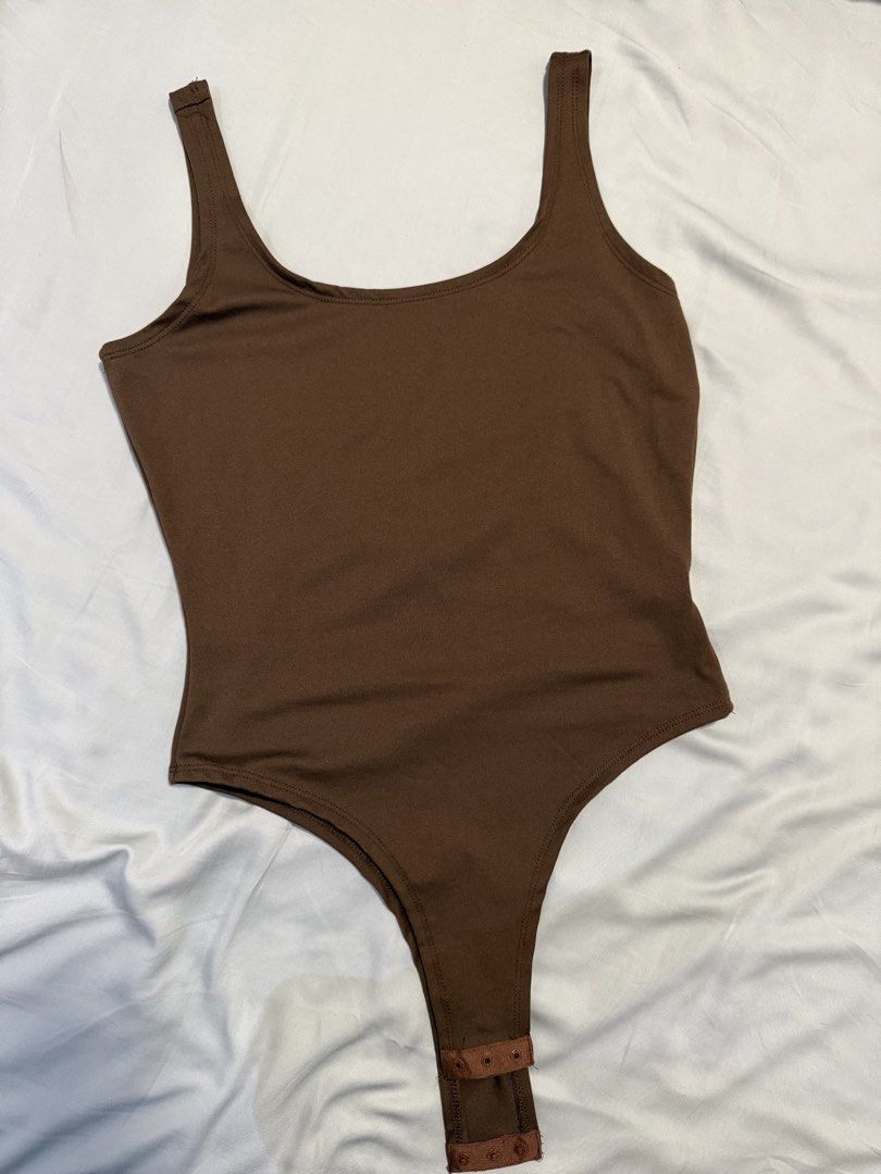 SHEIN Brown Scoop Neck Bodysuit (Category: Others Tops) located in Dasmarinas. Submitted by denmae (Listing ID 1462905677, Image 1). Description: - Brown scoop neck bodysuit from SHEIN - Made of comfortable and stretchy polyester/spandex blend - Versatile basic for layering or wearing on its own -Low back detail.