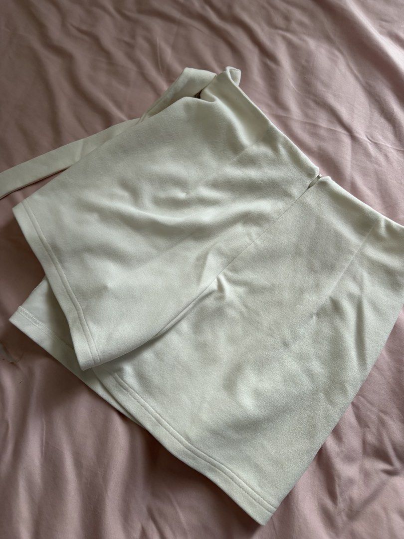 SHEIN White D-Ring Wrap Skort Size M (Category: Shorts) located in Manila. Submitted by leean0924 (Listing ID 1462885593, Image 3). Description: - White skort from SHEIN - Size: Medium (M) - Design: Wrap front with D-ring detail - Closure: Side zipper - Origin: Made in China - Versatile: Suitable for casual outings or dressing up.