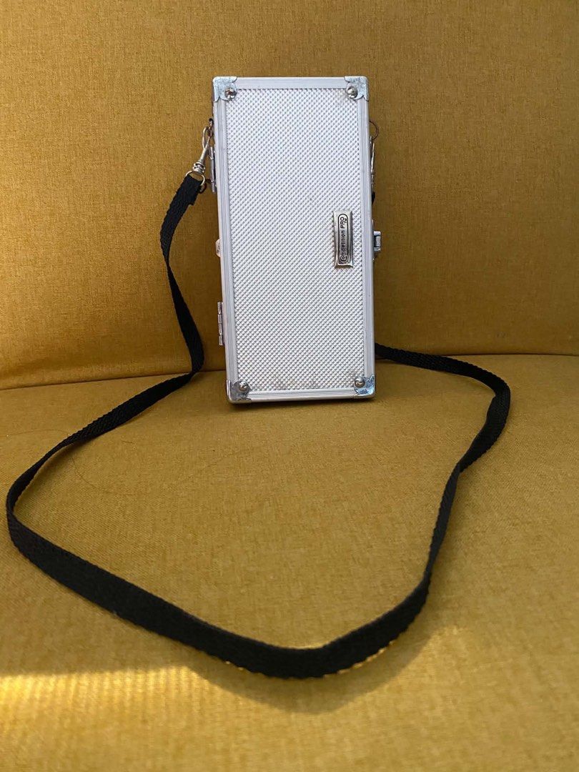 Silver Mini Hard Case Bag with Strap (Category: Cross-body Bags) located in Quezon City. Submitted by heybailey (Listing ID 1462947610, Image 1). Description: - Cool silver hard case bag - Textured finish - Detachable black strap - Ideal for small essentials (phone, cards) - Perfect for a night out.
