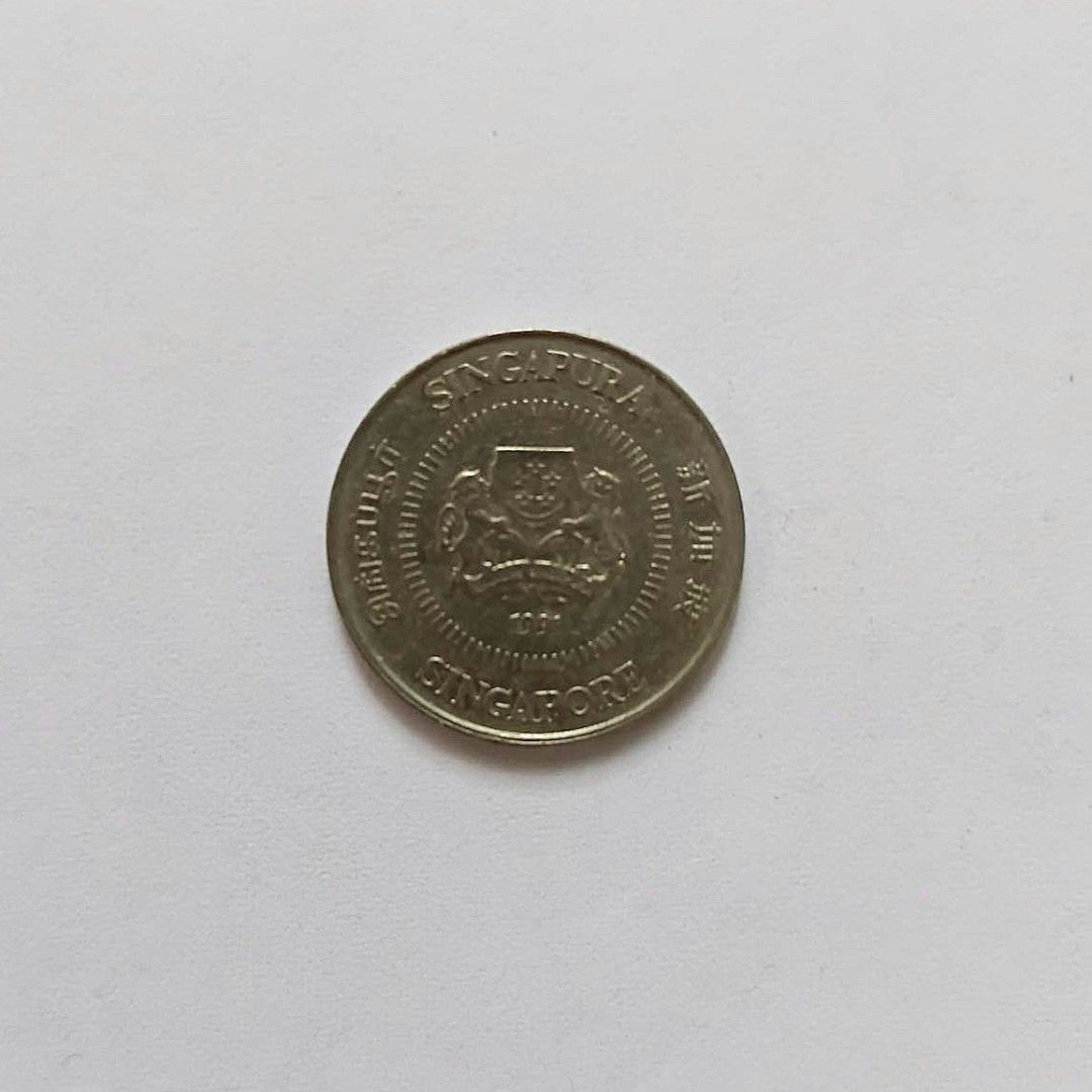 Singapore 10 Cents Coin (Category: Currency) located in Bacoor. Submitted by hazirannei (Listing ID 1462962420, Image 2). Description: - Authentic Singapore 10 cents coin - Features the national coat of arms on one side - Reverse side displays palm trees and the denomination '10' - Ideal addition for coin collectors RfS: Decluttering MoP: GCash MoD: LBC, J&T Express or Buyer's preferred Courier if thru online booking. Shipping Fee at Buyer's expe