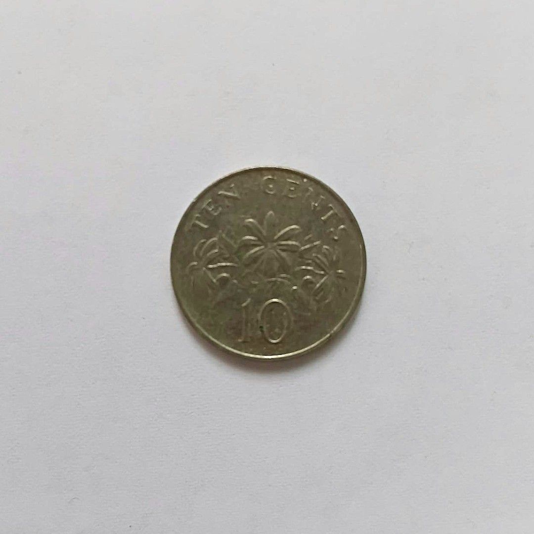 Singapore 10 Cents Coin (Category: Currency) located in Bacoor. Submitted by hazirannei (Listing ID 1462962420, Image 1). Description: - Authentic Singapore 10 cents coin - Features the national coat of arms on one side - Reverse side displays palm trees and the denomination '10' - Ideal addition for coin collectors RfS: Decluttering MoP: GCash MoD: LBC, J&T Express or Buyer's preferred Courier if thru online booking. Shipping Fee at Buyer's expe