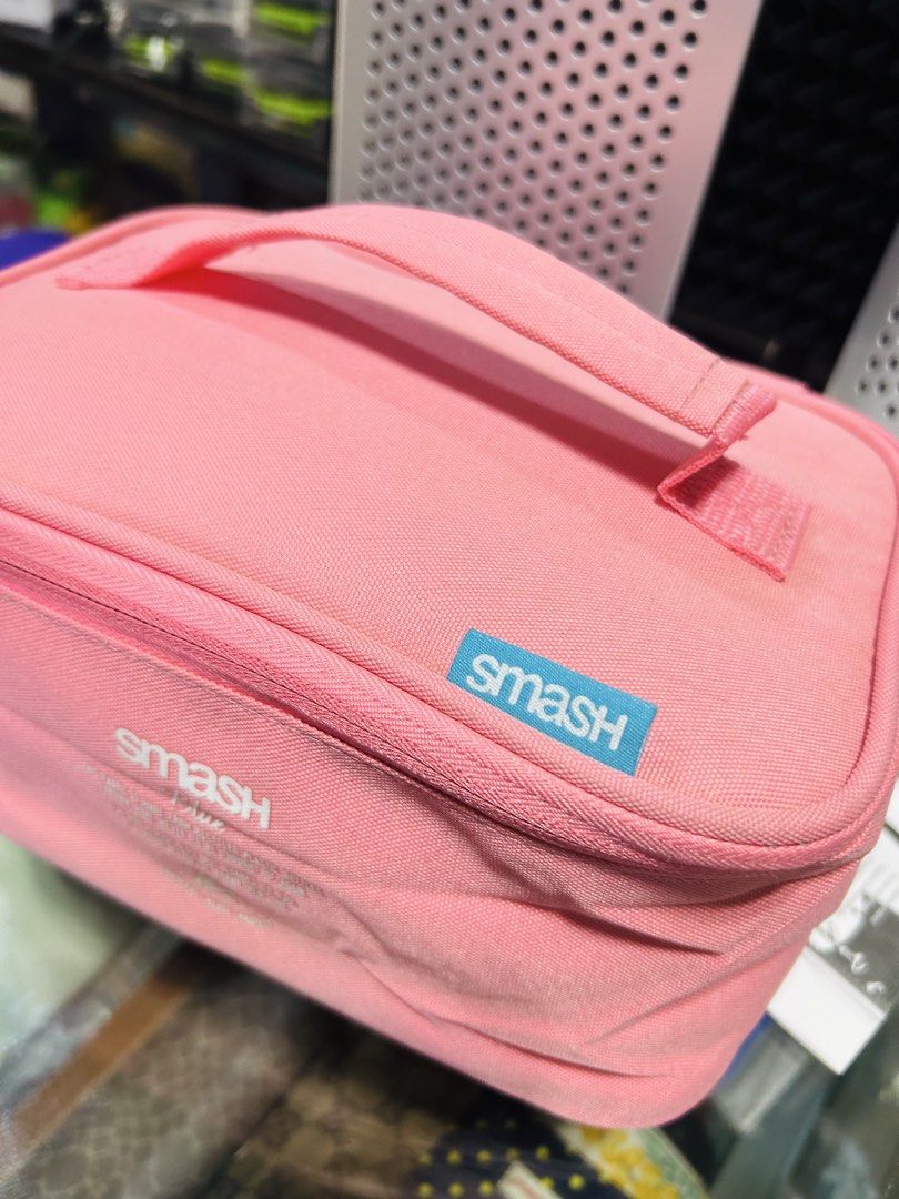 Smash Blue Pink Cosmetic Bag Organizer (Category: Purses & Pouches) located in Manila. Submitted by starbalesukandjapansurplus (Listing ID 1462905587, Image 2). Description: - Pink Smash Blue cosmetic bag - Features a convenient handle - Secure zipper closure - Interior elastic straps for organization - Lined with a shiny blue material - Ideal for makeup or toiletries - Easy to carry for travel or everyday use.