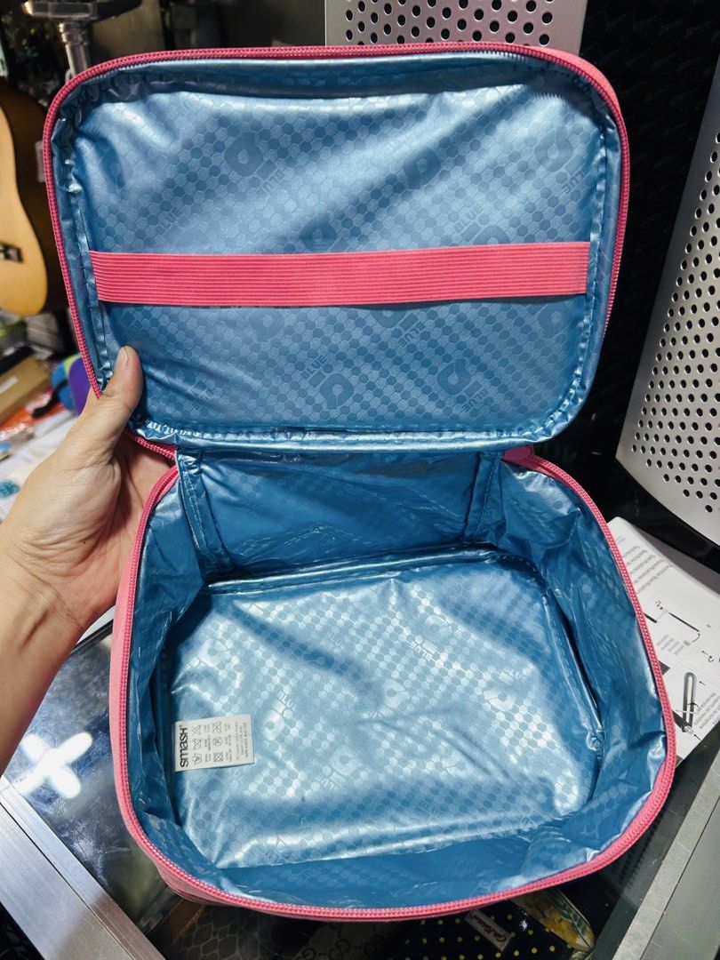 Smash Blue Pink Cosmetic Bag Organizer (Category: Purses & Pouches) located in Manila. Submitted by starbalesukandjapansurplus (Listing ID 1462905587, Image 3). Description: - Pink Smash Blue cosmetic bag - Features a convenient handle - Secure zipper closure - Interior elastic straps for organization - Lined with a shiny blue material - Ideal for makeup or toiletries - Easy to carry for travel or everyday use.