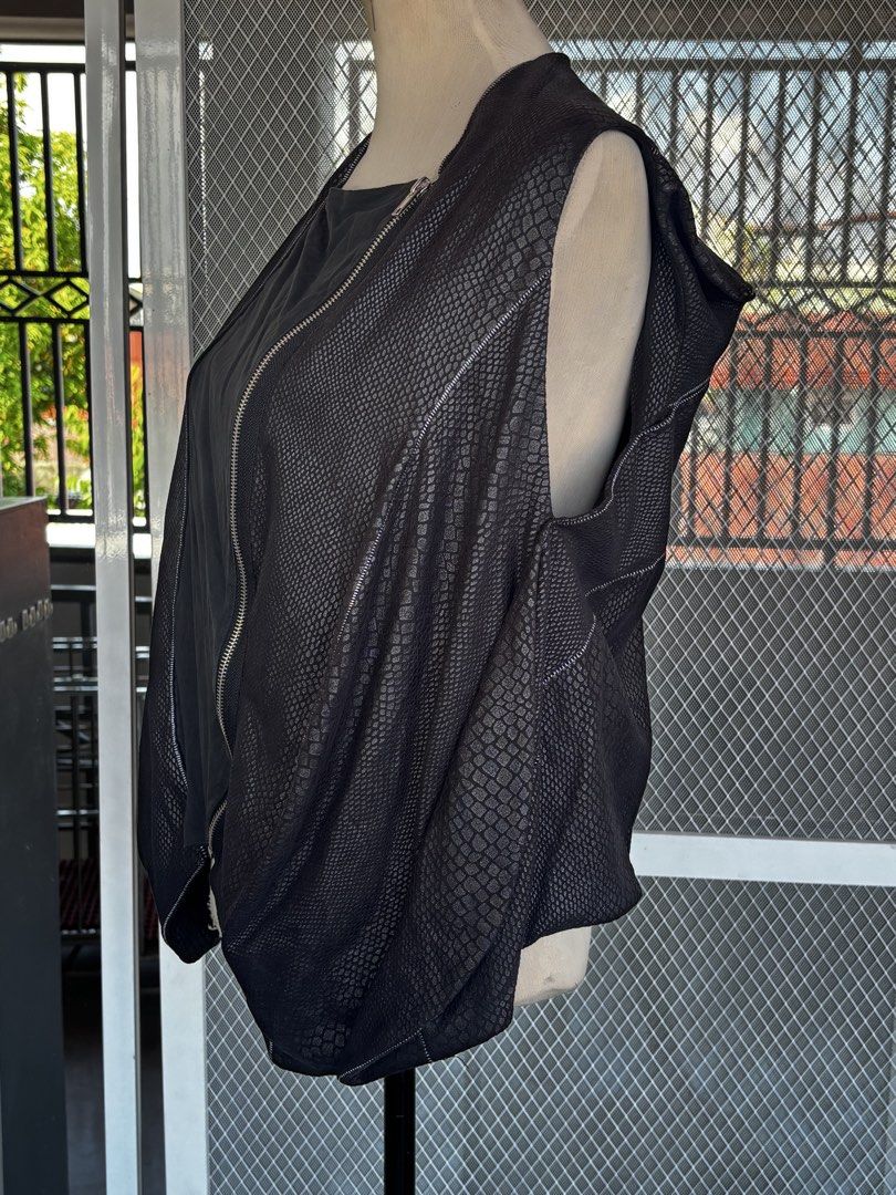 Snakeskin Asymmetrical Closure Vest (Category: Sleeveless) located in Apalit. Submitted by orchid555_ (Listing ID 1462944542, Image 3). Description: - Textured snake-skin like pattern - Asymmetrical zipper front - Sleeveless design - Unique stitching details - Drapes nicely.