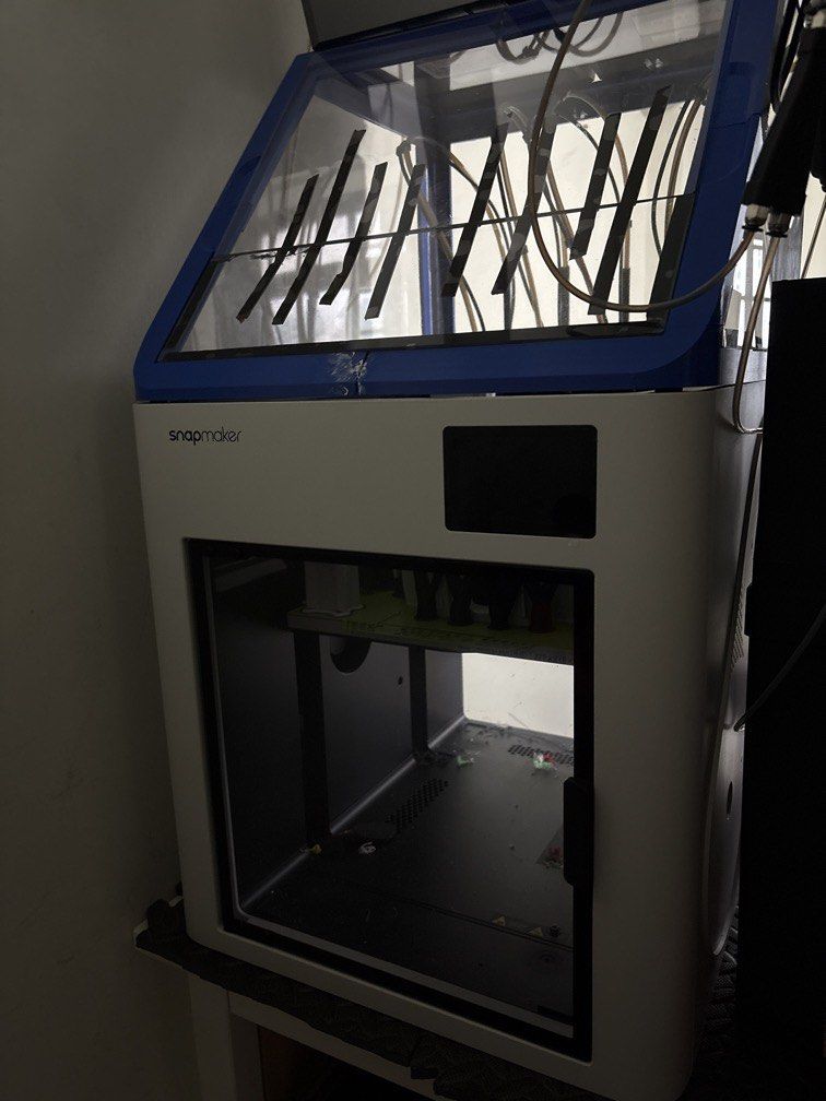 Snapmaker U1 (Category: Printers, Scanners & Copiers) located in Singapore. Submitted by koechink (Listing ID 1462885355, Image 1). Description: - Snapmaker 3D printer - Clear enclosure with blue trim - Interior shows some dust and debris - Front panel screen visible - Sold as is.