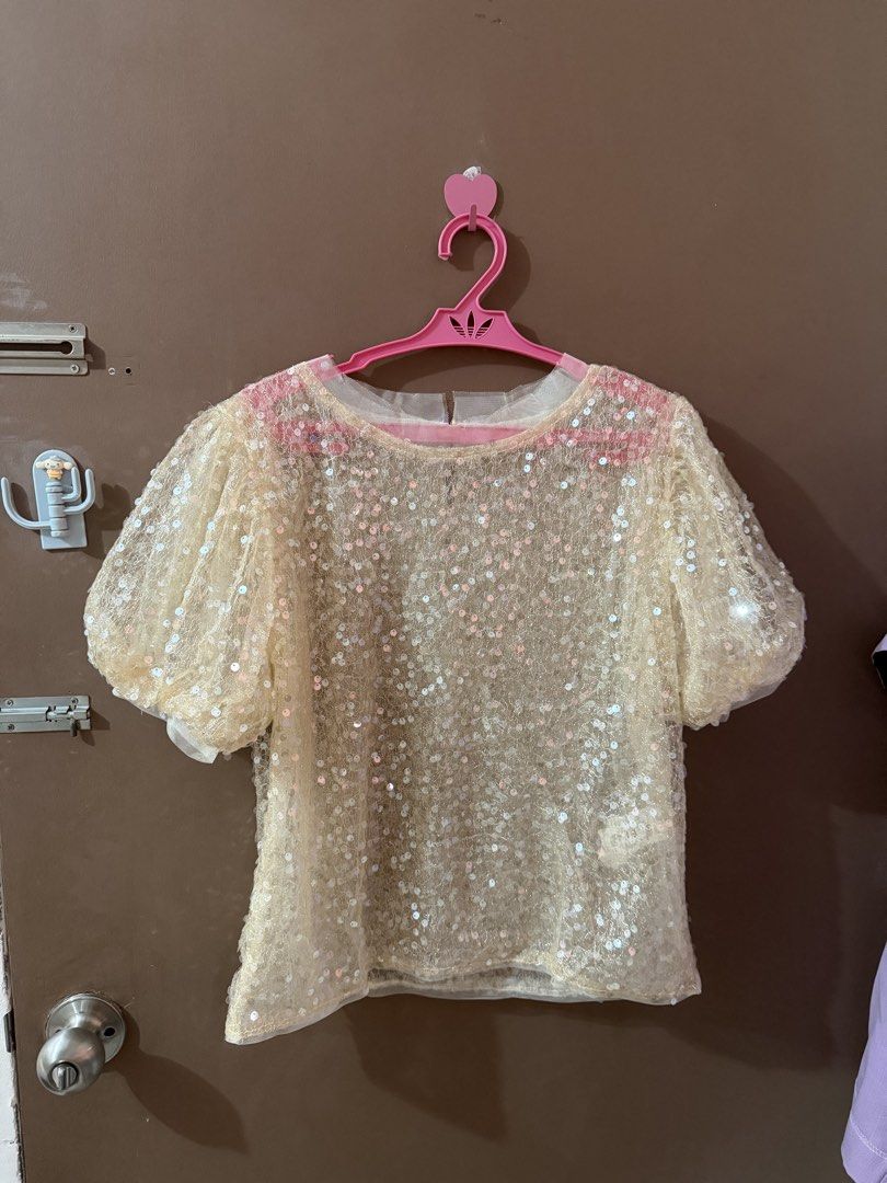 Sparkly Sequin Puff Sleeve Top (Category: Blouses) located in Davao. Submitted by fabdeclutter (Listing ID 1463068455, Image 2). Description: - Cream colored top with all-over sequins - Features short puff sleeves - Round neckline - Sheer fabric with a subtle shimmer - Ideal for parties or a night out - Versatile: pairs well with skirts or pants - Festive and fun design.