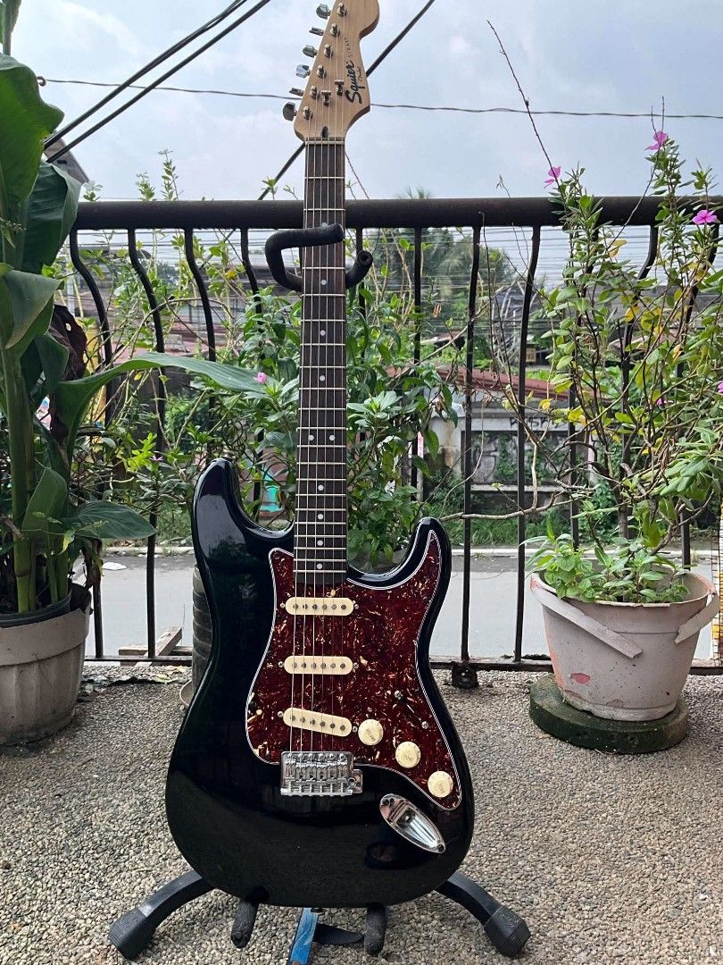 Squier by Fender Stratocaster Electric Guitar (Category: Musical Instruments) located in Caloocan City. Submitted by jhunixemberda-78114 (Listing ID 1463117216, Image 2). Description: - Black Squier Stratocaster by Fender - Tortoiseshell pickguard - Three single-coil pickups - Maple neck with rosewood fretboard - Chrome tuners - Crafted in Indonesia - Ideal for playing music.