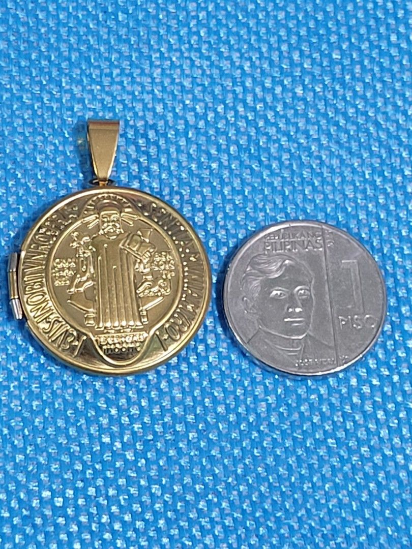 ST. BENEDICT LOCKET PENDANT AUTHENTIC STAINLESS GOLD BACK TO BACK DESIGN (Category: Religious Items) located in Makati City. Submitted by juriexpi (Listing ID 1462945133, Image 1). Description: ST. BENEDICT LOCKET PENDANT AUTHENTIC STAINLESS GOLD BACK TO BACK DESIGN brand new non tarnish stainless silver what you see is what you get comes with gift pouch as packaging.