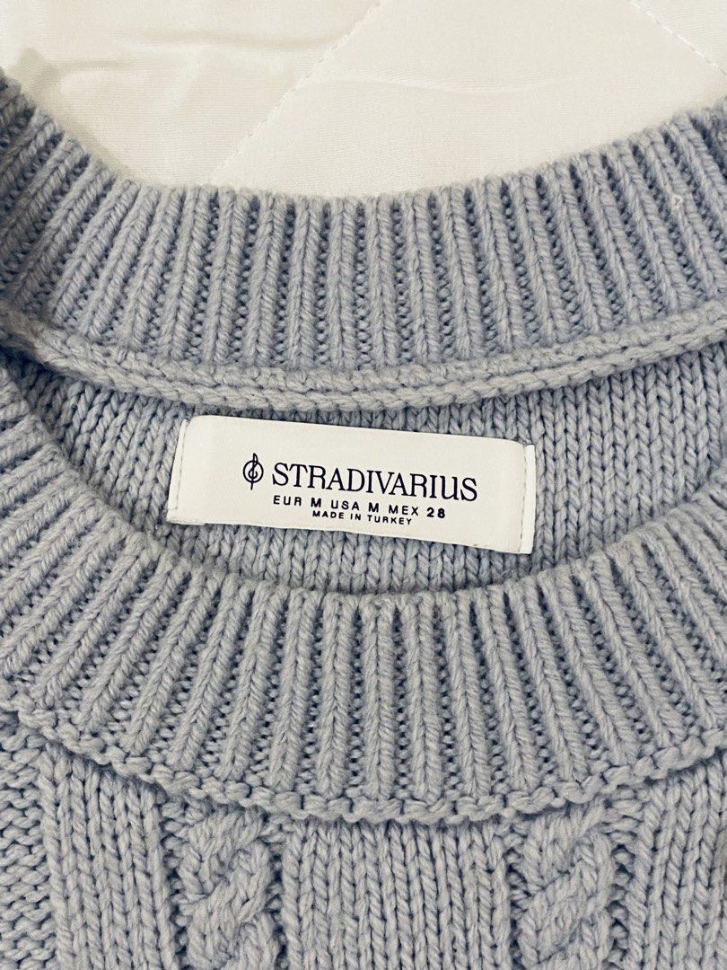Stradivarius Cable Knit Sweater (Category: Longsleeves) located in Iloilo. Submitted by shopfromhomeph.co (Listing ID 1462970588, Image 2). Description: - Light blue Stradivarius sweater - Cozy cable knit design - Unique cut-out details on sleeves and body - Crew neck, long sleeves - Perfect for stylish layering.