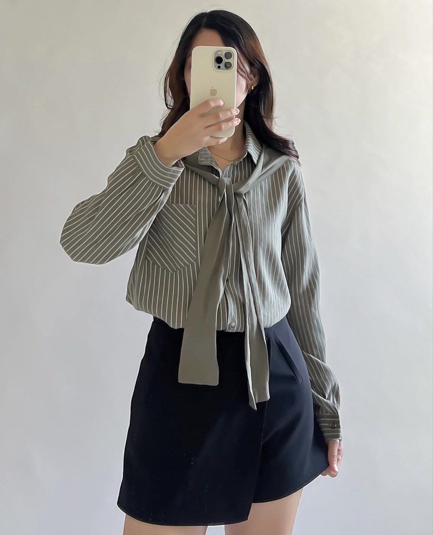 Striped Button-Up Shirt with Tie Detail (Category: Shirts) located in Leyte. Submitted by modernpersephone (Listing ID 1463046094, Image 1). Description: - Olive green shirt with white pinstripes - Chest pocket on the left - Adjustable tie detail for versatile styling - Long sleeves - Button-up front - Can be worn tucked in or loose - Comfortable fabric.