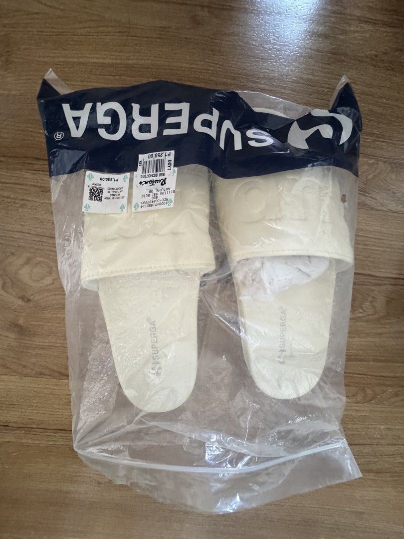 Superga Cream Slides (Category: Slippers and slides) located in Taguig. Submitted by misstangerine (Listing ID 1462950768, Image 3). Description: - Cream Superga slides - Super comfy and easy to slip on - Embossed Superga logo on the strap - Comes in original packaging - Great for casual wear or lounging.