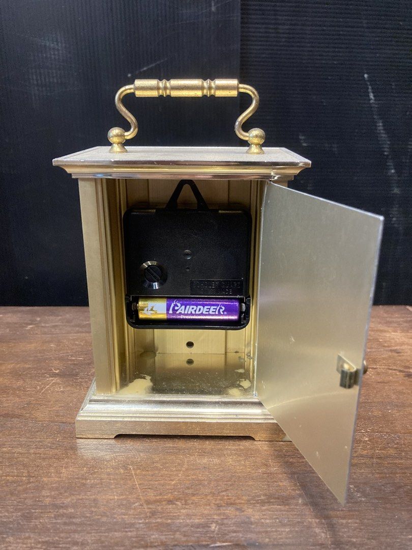 Table clock (Category: Clocks) located in Kuala Lumpur. Submitted by gninevintage (Listing ID 1463085826, Image 2). Description: - Elegant brass carriage clock with a convenient top handle. - Features classic Roman numerals on the clock face. - Reliable Swiss quartz movement for accurate timekeeping. - Battery operated for easy use. - Stands approximately 7 inches tall. - In excellent working condition..