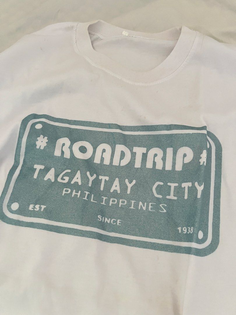Tagaytay Graphic T-shirt (Category: Tshirts & Polo Shirts ) located in Manila. Submitted by happydani (Listing ID 1462965056, Image 2). Description: - XL - White graphic t-shirt - Features a 'Roadtrip Tagaytay City Philippines' print - Teal rectangular design with text - Ideal for casual wear or as a souvenir - Great for road trips and exploring Tagaytay.