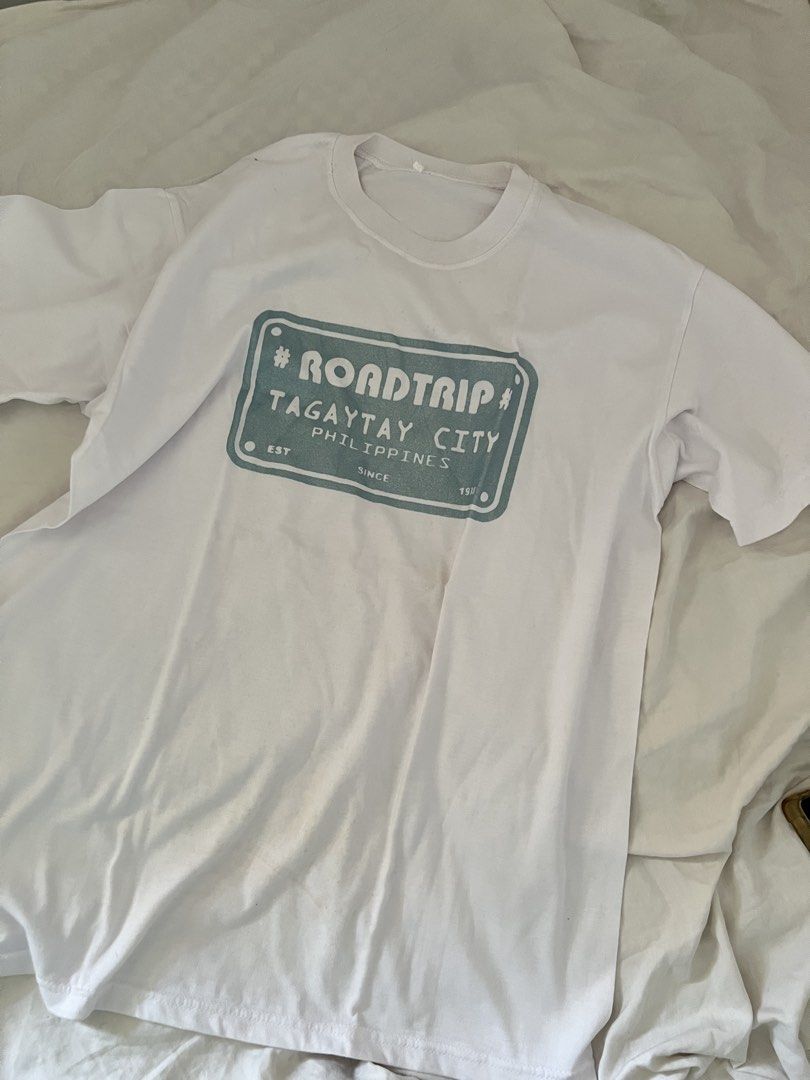 Tagaytay Graphic T-shirt (Category: Tshirts & Polo Shirts ) located in Manila. Submitted by happydani (Listing ID 1462965056, Image 1). Description: - XL - White graphic t-shirt - Features a 'Roadtrip Tagaytay City Philippines' print - Teal rectangular design with text - Ideal for casual wear or as a souvenir - Great for road trips and exploring Tagaytay.