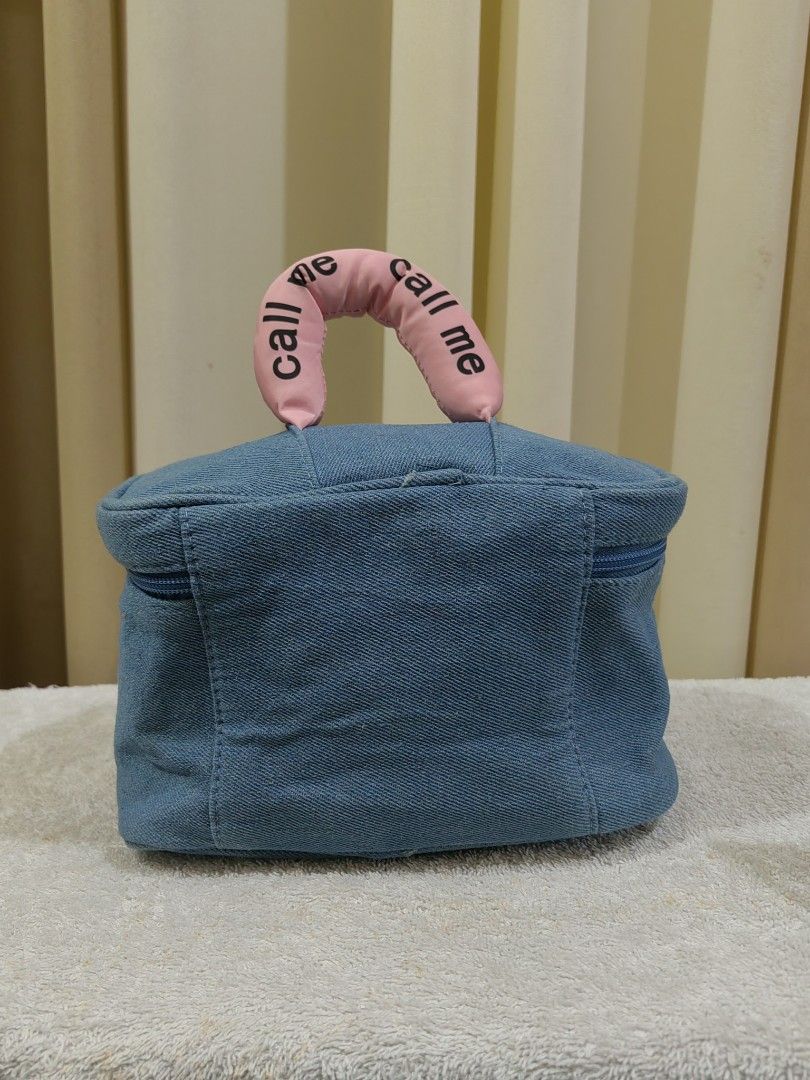 Tagi Denim Cosmetic Bag with Handle (Category: Luxury Bags & Wallets) located in Makati City. Submitted by prelovedtreatedwithlove (Listing ID 1463016927, Image 2). Description: - Cute Tagi denim cosmetic bag - Pink handle with unique number - Secure zipper closure - Interior features a mesh pocket and dividers for organization - Ideal for storing makeup, toiletries, or other small essentials - like new A-095.