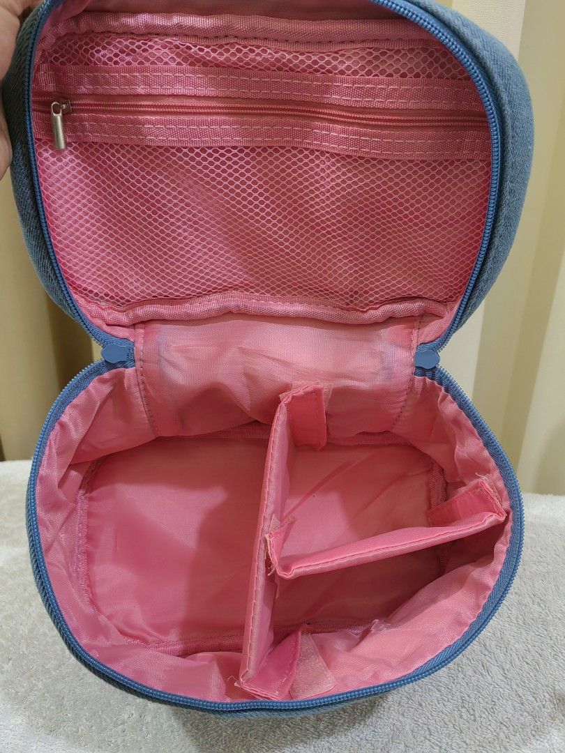 Tagi Denim Cosmetic Bag with Handle (Category: Luxury Bags & Wallets) located in Makati City. Submitted by prelovedtreatedwithlove (Listing ID 1463016927, Image 3). Description: - Cute Tagi denim cosmetic bag - Pink handle with unique number - Secure zipper closure - Interior features a mesh pocket and dividers for organization - Ideal for storing makeup, toiletries, or other small essentials - like new A-095.