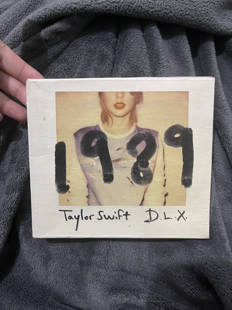 Taylor Swift 1989 Deluxe Edition CD (Category: CDs & DVDs) located in Cebu City. Submitted by santisanta66891 (Listing ID 1463060605, Image 1). Description: - Taylor Swift's 1989 Deluxe Edition CD - Includes bonus tracks and exclusive photos - Essential for any Taylor Swift fan's collection - Own a piece of this iconic album.