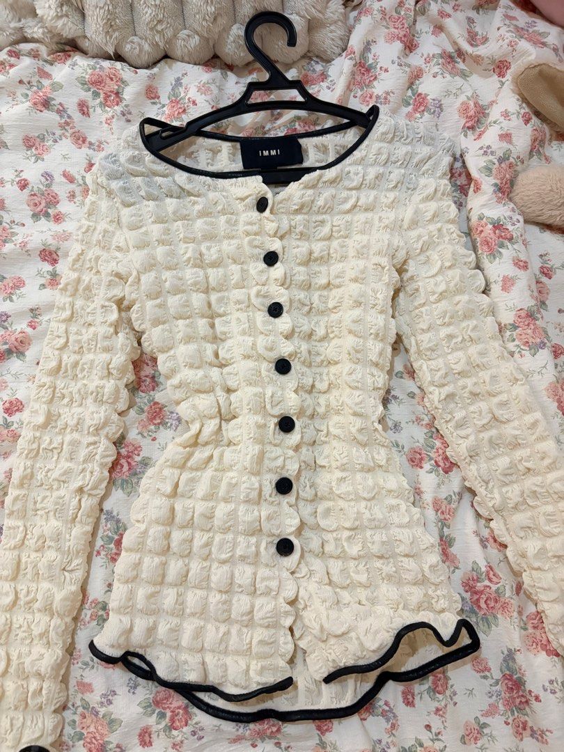 Textured Button-Up Cardigan Cream Black Trim (Category: Coats, Jackets and Outerwear) located in Manila. Submitted by ellaineju58379 (Listing ID 1462977860, Image 1). Description: - Cream textured cardigan from IMMI - Features black trim along neckline and hem - Button-up front with black buttons - Long sleeves - Unique crinkled fabric texture - Perfect for layering or wearing solo.