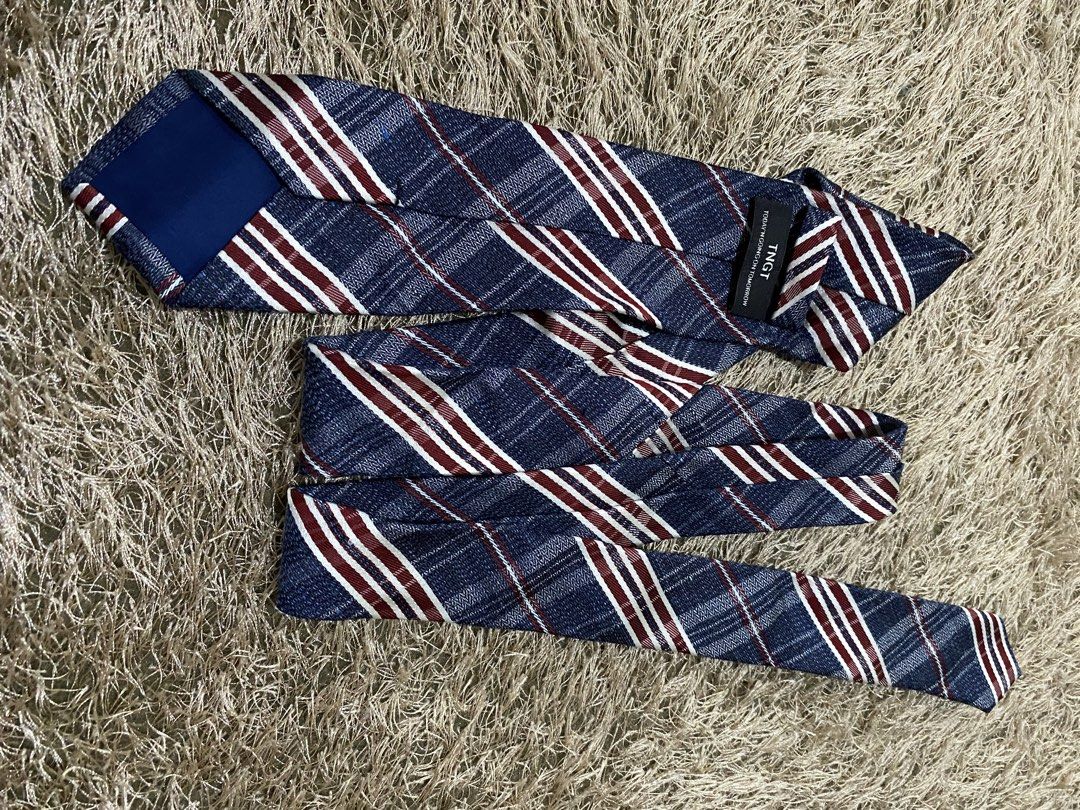 TGST Blue Plaid Striped Necktie (Category: Ties) located in Bulacan. Submitted by rich2545 (Listing ID 1462905786, Image 2). Description: - Blue necktie - Features red and white stripes - Plaid pattern throughout - Textured fabric for a unique look - Perfect for elevating any outfit.