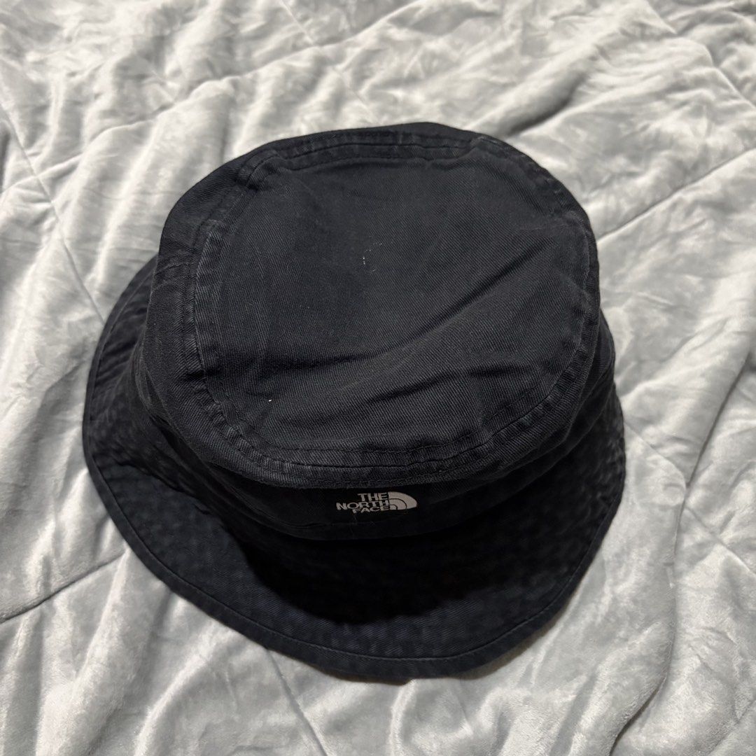 The North Face Black Bucket Hat (Category: Caps & Hats) located in Carmen. Submitted by rr_thrifts (Listing ID 1462952305, Image 3). Description: - Classic black bucket hat - Brand: The North Face - Material: Durable fabric - Versatile design for sunny days or streetwear - Fits most head sizes - Essential wardrobe accessory.