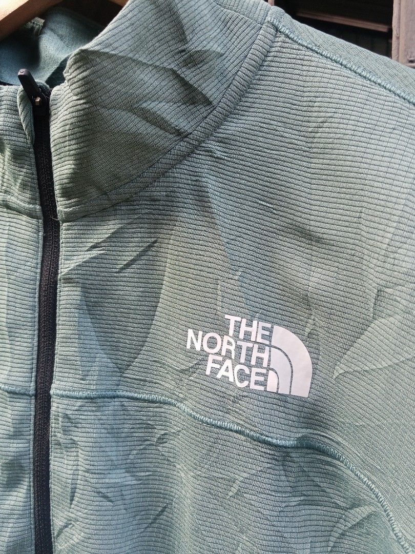 The North Face Men's Quarter Zip Pullover Shirt (Category: Tshirts & Polo Shirts ) located in Lingayen. Submitted by rahzzelula73279 (Listing ID 1463065113, Image 2). Description: - Brand: The North Face - Color: Light Green - Style: Quarter Zip Pullover - Size: US L / Asia XL - Origin: Made in Vietnam - Features: Textured fabric pattern, black zipper, embroidered chest logo - Ideal for: Outdoor activities, casual wear.