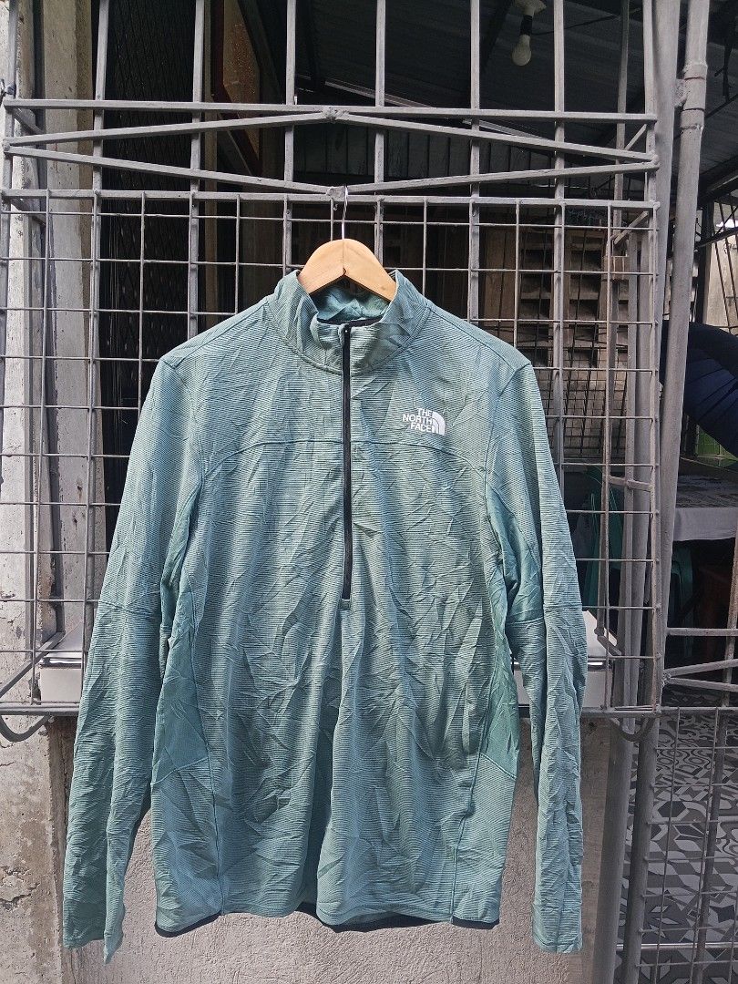 The North Face Men's Quarter Zip Pullover Shirt (Category: Tshirts & Polo Shirts ) located in Lingayen. Submitted by rahzzelula73279 (Listing ID 1463065113, Image 1). Description: - Brand: The North Face - Color: Light Green - Style: Quarter Zip Pullover - Size: US L / Asia XL - Origin: Made in Vietnam - Features: Textured fabric pattern, black zipper, embroidered chest logo - Ideal for: Outdoor activities, casual wear.