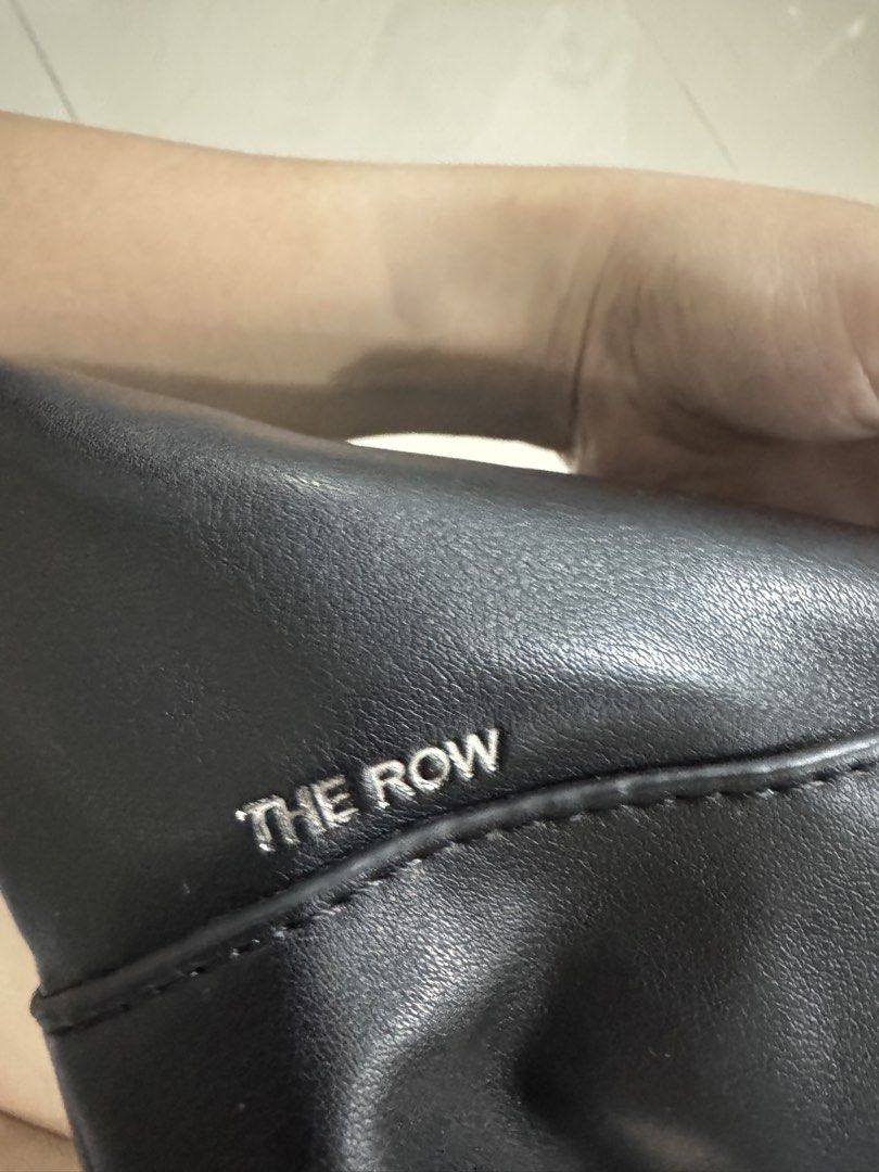 The Row Leather Terrase Shoulder Bag Black (Category: Luxury Bags & Wallets) located in Bacolod City. Submitted by matahum.bcd (Listing ID 1463061025, Image 3). Description: - The Row Terrase shoulder bag - Material: Black calfskin leather - Features a stylish scarf tied to the handle - Interior includes zippered pockets for organization - Ideal for everyday use .