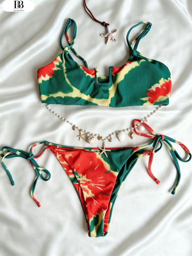 Tie-dye Bikini Set with Shell Necklace (Category: Bikinis & Swimsuits) located in Compostela. Submitted by shopbybeverly (Listing ID 1463011289, Image 1). Description: - Good quality for its price -Super cute tie-dye bikini set - Vibrant green, red, and yellow pattern - Top features adjustable straps and U-neckline - Bottoms are tie-side style - Comes with a shell and starfish beaded necklace - Ideal for beach days or pool parties.