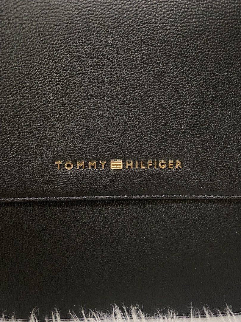 Tommy Hilfiger Crossbody Bag (Category: Cross-body Bags) located in San Antonio. Submitted by clinicallycute_. (Listing ID 1463037224, Image 2). Description: - Classic black Tommy Hilfiger crossbody bag - Textured leather exterior - Gold logo detail - Navy interior lining with red brand tag - Made in Cambodia - Adjustable strap for comfortable wear - Ideal for everyday use.