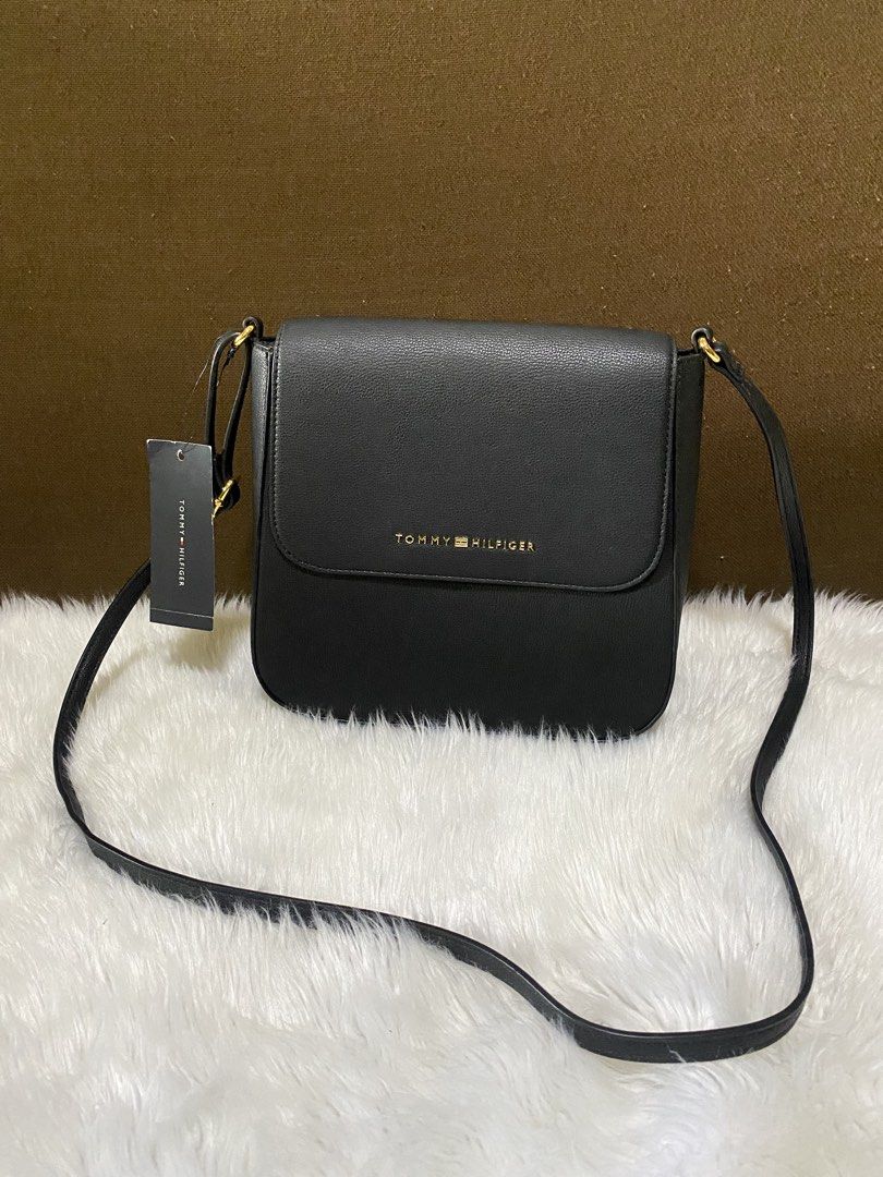 Tommy Hilfiger Crossbody Bag (Category: Cross-body Bags) located in San Antonio. Submitted by clinicallycute_. (Listing ID 1463037224, Image 1). Description: - Classic black Tommy Hilfiger crossbody bag - Textured leather exterior - Gold logo detail - Navy interior lining with red brand tag - Made in Cambodia - Adjustable strap for comfortable wear - Ideal for everyday use.