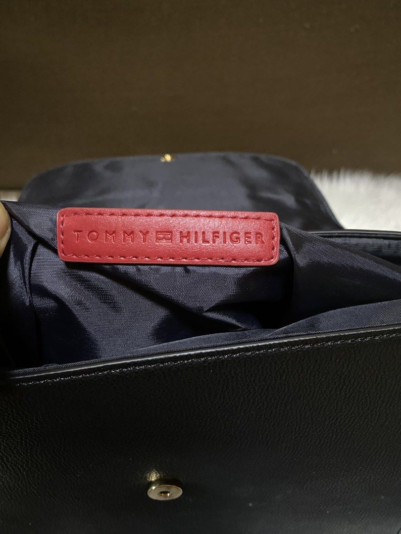 Tommy Hilfiger Crossbody Bag (Category: Cross-body Bags) located in San Antonio. Submitted by clinicallycute_. (Listing ID 1463037224, Image 3). Description: - Classic black Tommy Hilfiger crossbody bag - Textured leather exterior - Gold logo detail - Navy interior lining with red brand tag - Made in Cambodia - Adjustable strap for comfortable wear - Ideal for everyday use.