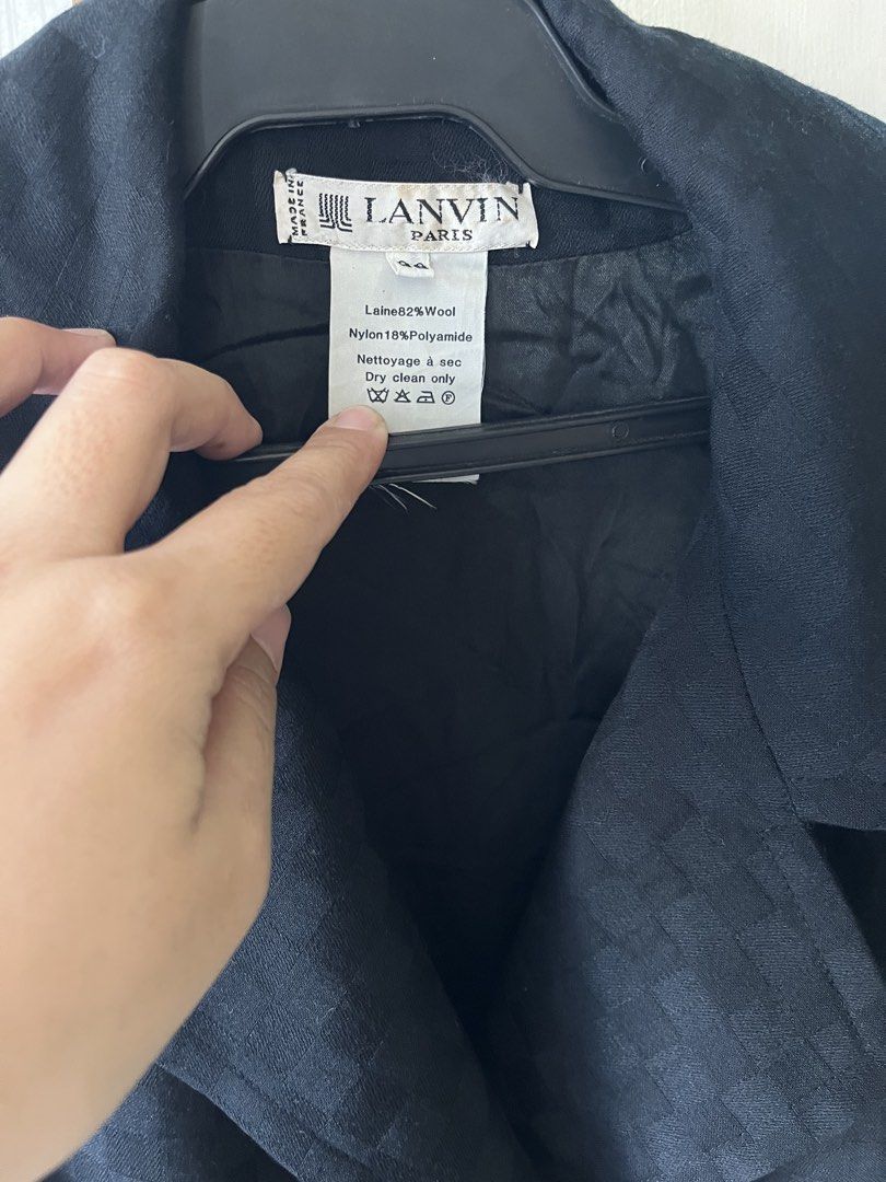 Trench coat (Category: Coats, Jackets and Outerwear) located in Bacoor. Submitted by ayit. (Listing ID 1462928119, Image 3). Description: Negotiable sf inc Med-large fit orig personal japan gling sf inc nego - Brand: Lanvin Paris - Type: Trench Coat - Color: Black - Size: M (EU 38/UK 10/US 6) - Material: 82% Wool, 18% Polyamide - Design: Classic trench style with subtle checkered pattern - Features: Button-up front, two front pockets - Care: Dry 