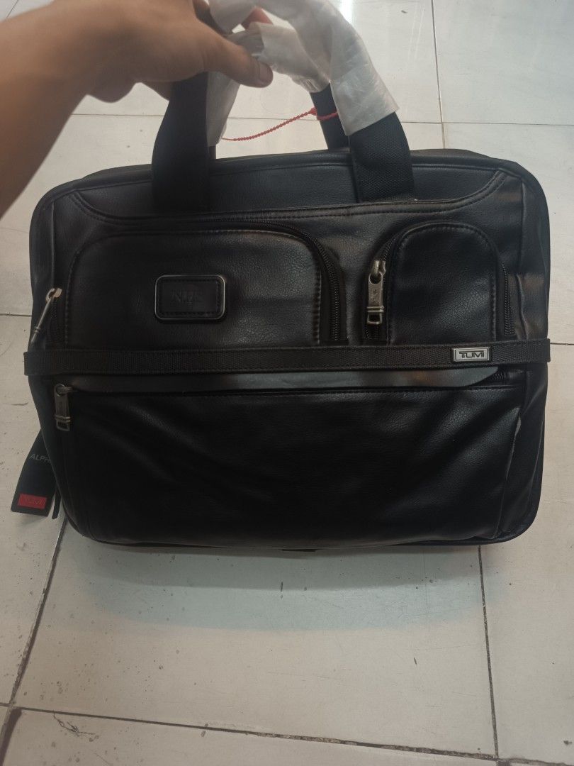 Tumi Alpha 3 Briefcase - Black Leather (Category: Briefcases) located in Bulacan. Submitted by the_j_thrift (Listing ID 1462970262, Image 1). Description: - Brand: Tumi Alpha 3 - Material: Black Leather - Features: Multiple zippered compartments - Condition: Brand new with original tags and luggage tag - Ideal for: Work and travel - Benefits: Durable and stylish design.