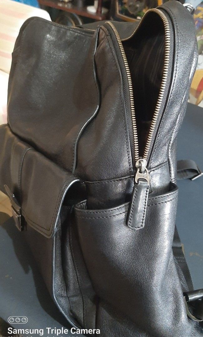 Tumi Beacon Hill Brimmer Black Leather Backpack (Category: Luxury Bags & Wallets) located in Orion. Submitted by atgalacio (Listing ID 1462934362, Image 3). Description: Tumi Beacon Hill Brimmer Leather Backpack (specifically style/model number 68580D). This is a premium, full-grain pebbled leather business backpack from Tumi's discontinued Beacon Hill collection. It features a classic vintage look, a distinctive signature metallic push-button cl