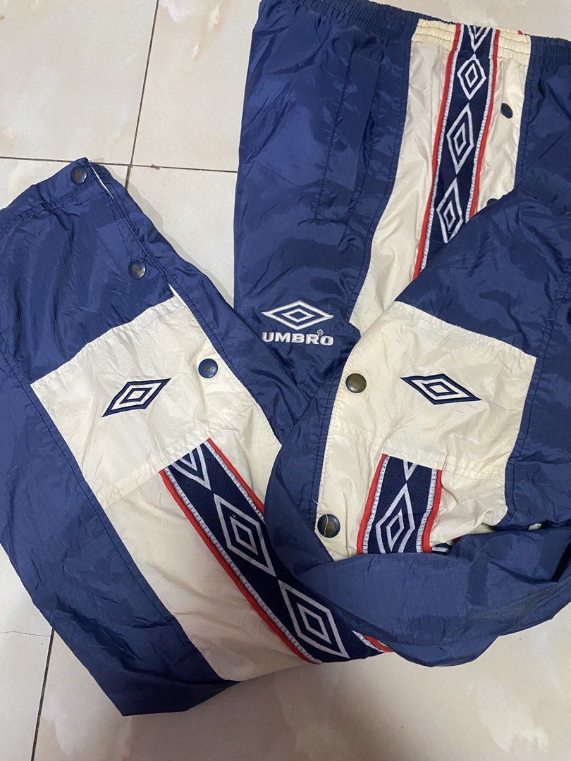 Umbro Vintage Track Pants Snap Button Side (Category: Joggers) located in Quezon City. Submitted by mgc_thriftshop (Listing ID 1462947239, Image 3). Description: - Vintage Umbro track pants - Size XL - Navy blue with cream and red side stripes - Full snap button closure on legs - Elastic waistband with drawstring - Umbro logo embroidered on left leg VTG umbro track pants size xl waistline 36 thigh 14.5 length 40 Hem 9 no issue excellent condition