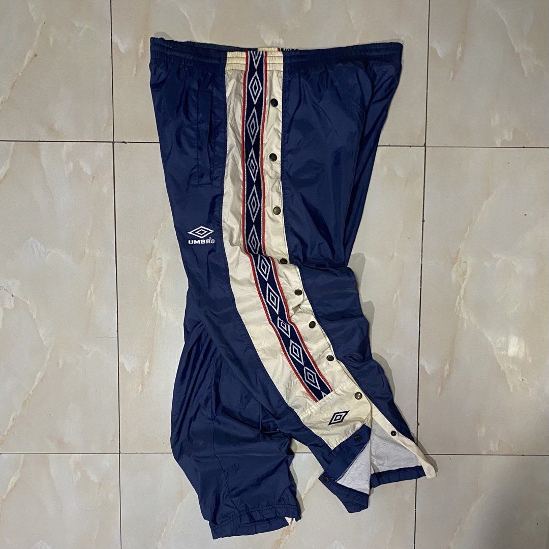 Umbro Vintage Track Pants Snap Button Side (Category: Joggers) located in Quezon City. Submitted by mgc_thriftshop (Listing ID 1462947239, Image 2). Description: - Vintage Umbro track pants - Size XL - Navy blue with cream and red side stripes - Full snap button closure on legs - Elastic waistband with drawstring - Umbro logo embroidered on left leg VTG umbro track pants size xl waistline 36 thigh 14.5 length 40 Hem 9 no issue excellent condition