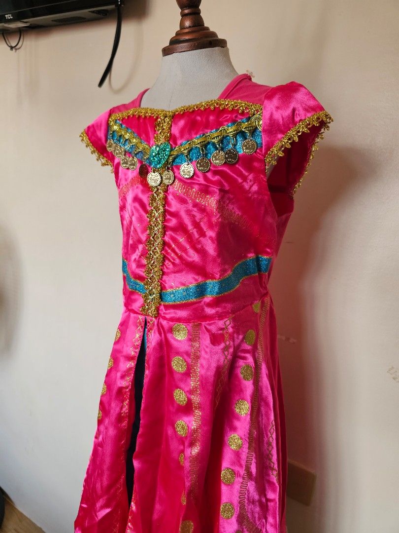 UN Costume Princess Jasmine (Category: Babies & Kids Fashion) located in General Trias. Submitted by myleneoh (Listing ID 1463021038, Image 3). Description: - Complete Saudi Arabia/ Princess Jamine costume for kids - Includes: dress, sash, headpiece, and necklace - Dress: Bright pink with gold and blue accents - Perfect for national costume events, cultural celebrations, halloween, or pretend play my daughter used this twice, as Princess Jasmine 