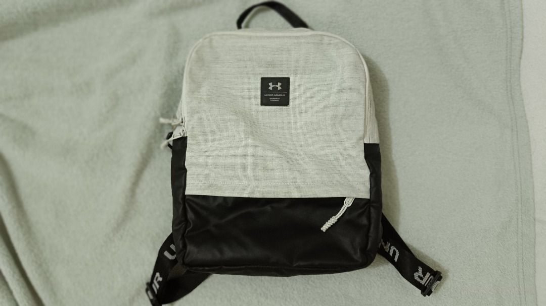 Under Armour Loudon Mini Backpack (Gray, 10L) (Category: Backpacks) located in Baguio. Submitted by onlymelope20980 (Listing ID 1463043405, Image 2). Description: - Brand: Under Armour - Color: White mesh top with black bottom - Features: Adjustable straps with Under Armour branding, main compartment with internal pockets - Ideal for: Everyday use, gym.