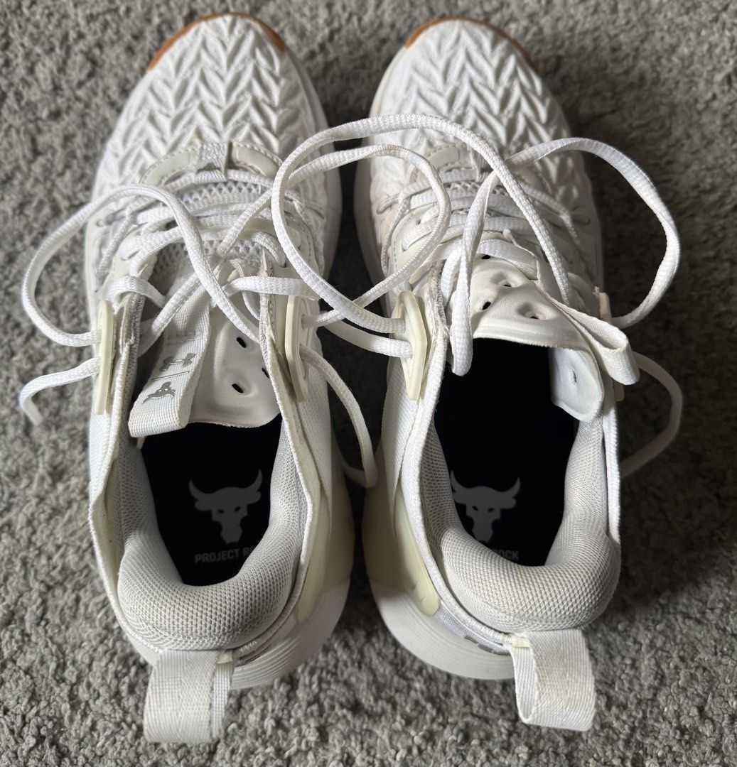 Under Armour Project Rock White Training Shoes (Category: Sneakers) located in Quezon City. Submitted by turak2020plus1 (Listing ID 1462972913, Image 2). Description: - White Under Armour Project Rock training shoes - Size: EUR 38 / UK 4.5 / US 7 - Made in Vietnam - Features Project Rock logo - Perfect for workouts or casual wear - No stains RFS: decluttering .